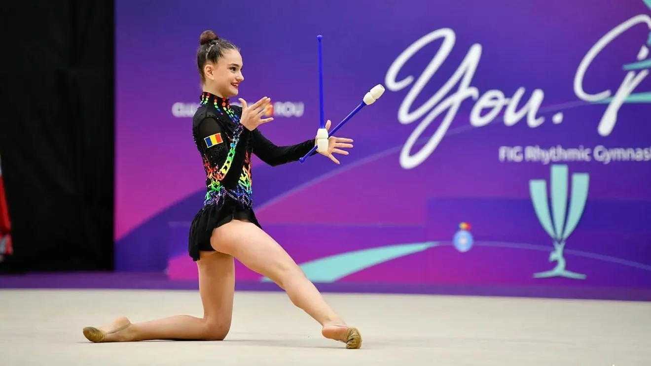Amalia Lică performing a rhythmic gymnastics routine with clubs at an international competition Amalia Lică performing a rhythmic gymnastics routine with clubs at an international competition