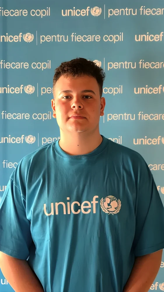 Nicholas Carstoiu in a UNICEF t-shirt, celebrated by the Romanian-Finnish High School after being named Volunteer of the Year in Romania at Gala Voluntarului Social 2026